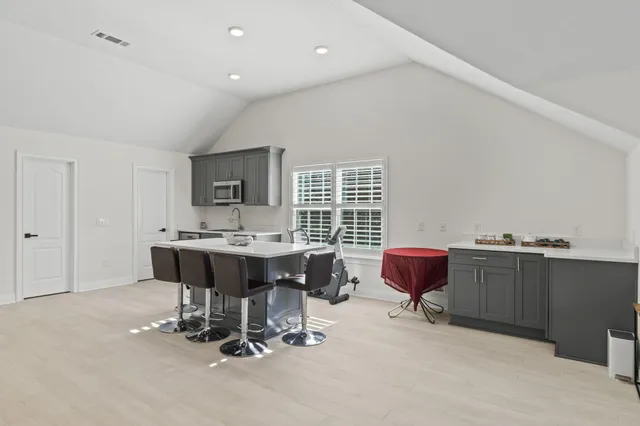 a kitchen with a sink cabinets and window