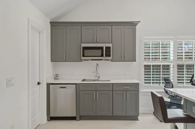 a view of a balcony with wooden floor and outdoor seating