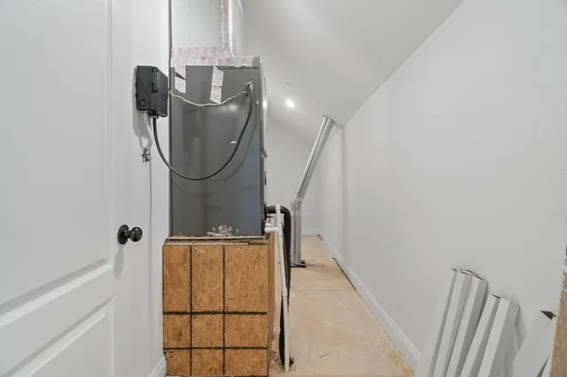a large white kitchen with granite countertop a sink and dishwasher with a large window