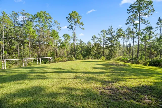 an aerial view of a houses with a yard