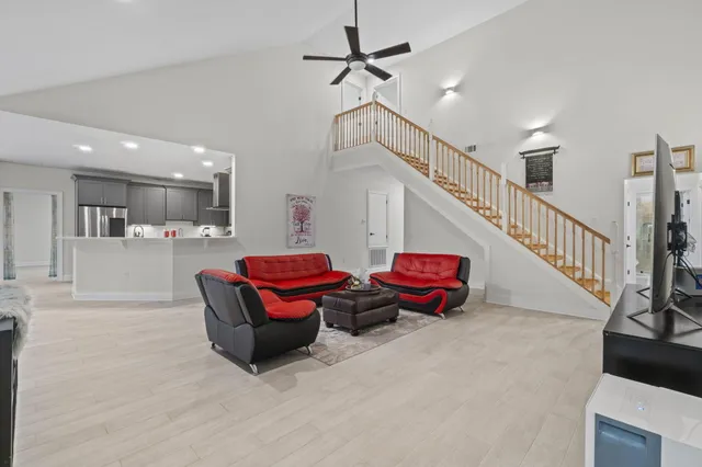 a living room with lots of furniture and air hockey table
