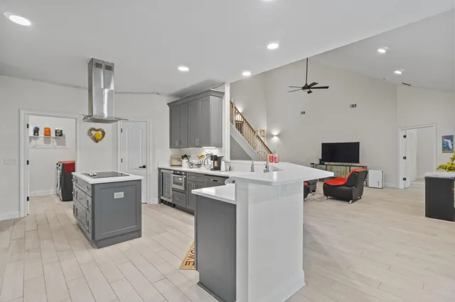 a large white kitchen with a stove and a refrigerator
