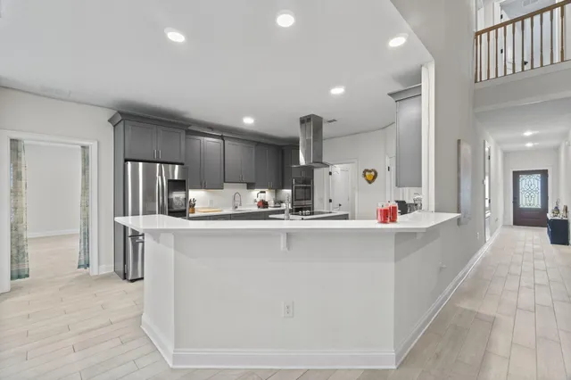 a kitchen with stainless steel appliances a sink stove and cabinets