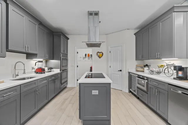 a kitchen with stainless steel appliances granite countertop a sink stove and refrigerator