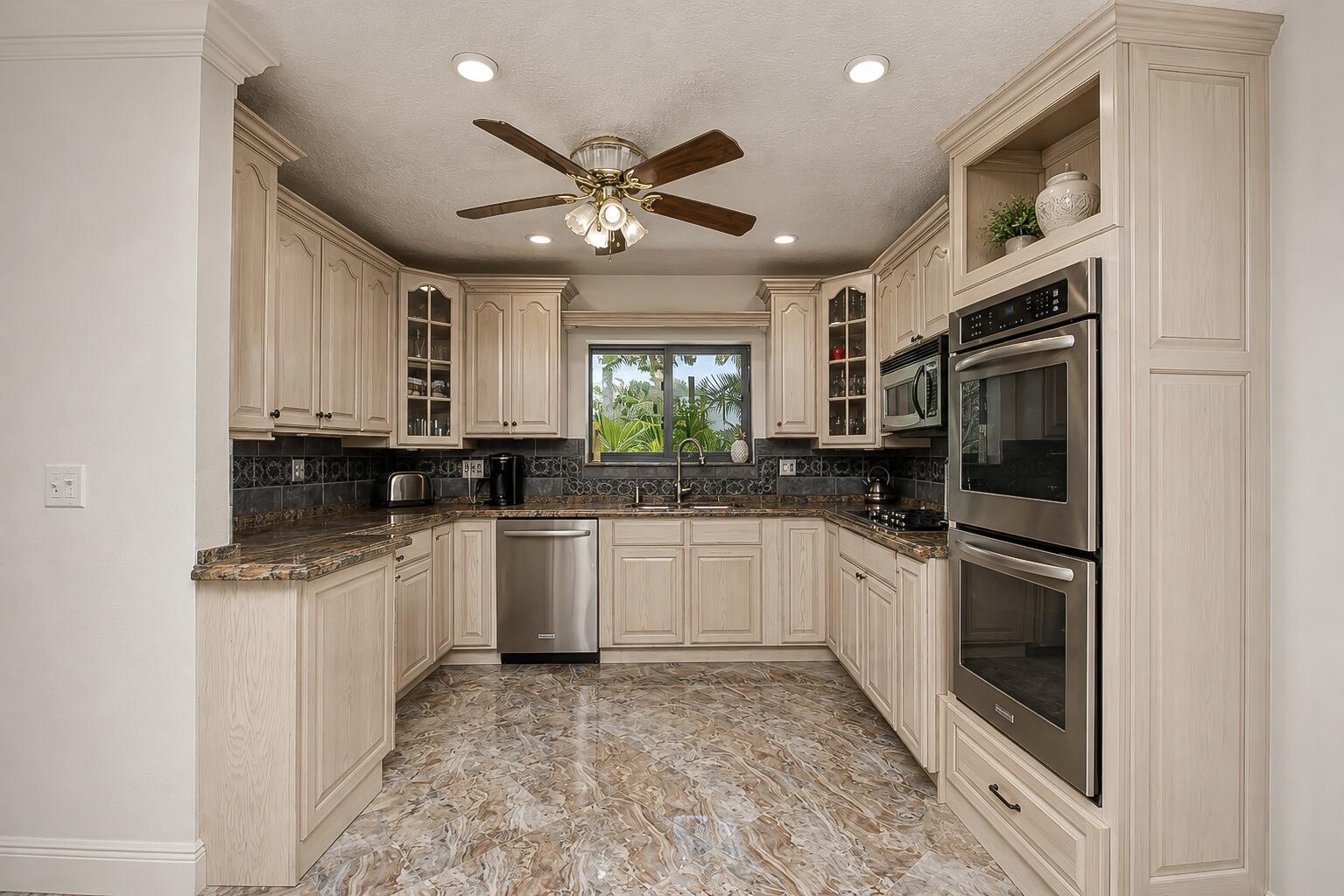 9708 Erica Court Boca Raton, FL 33496 - Photo 22 of 54 a kitchen with stainless steel appliances granite countertop a refrigerator and a stove top oven