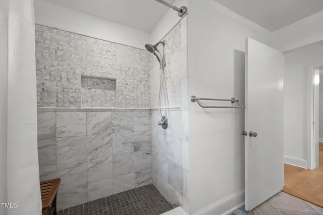 a view of a lake with a yard and large trees