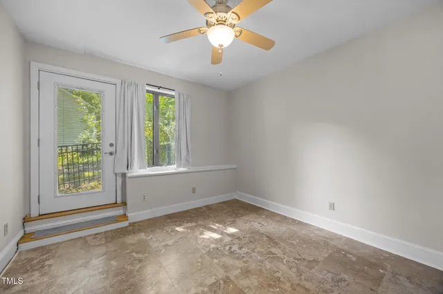 a view of swimming pool with seating area and trees in the background