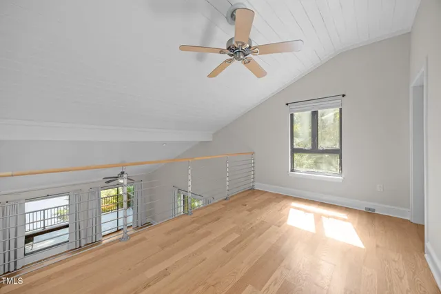 an aerial view of a houses with a lake view