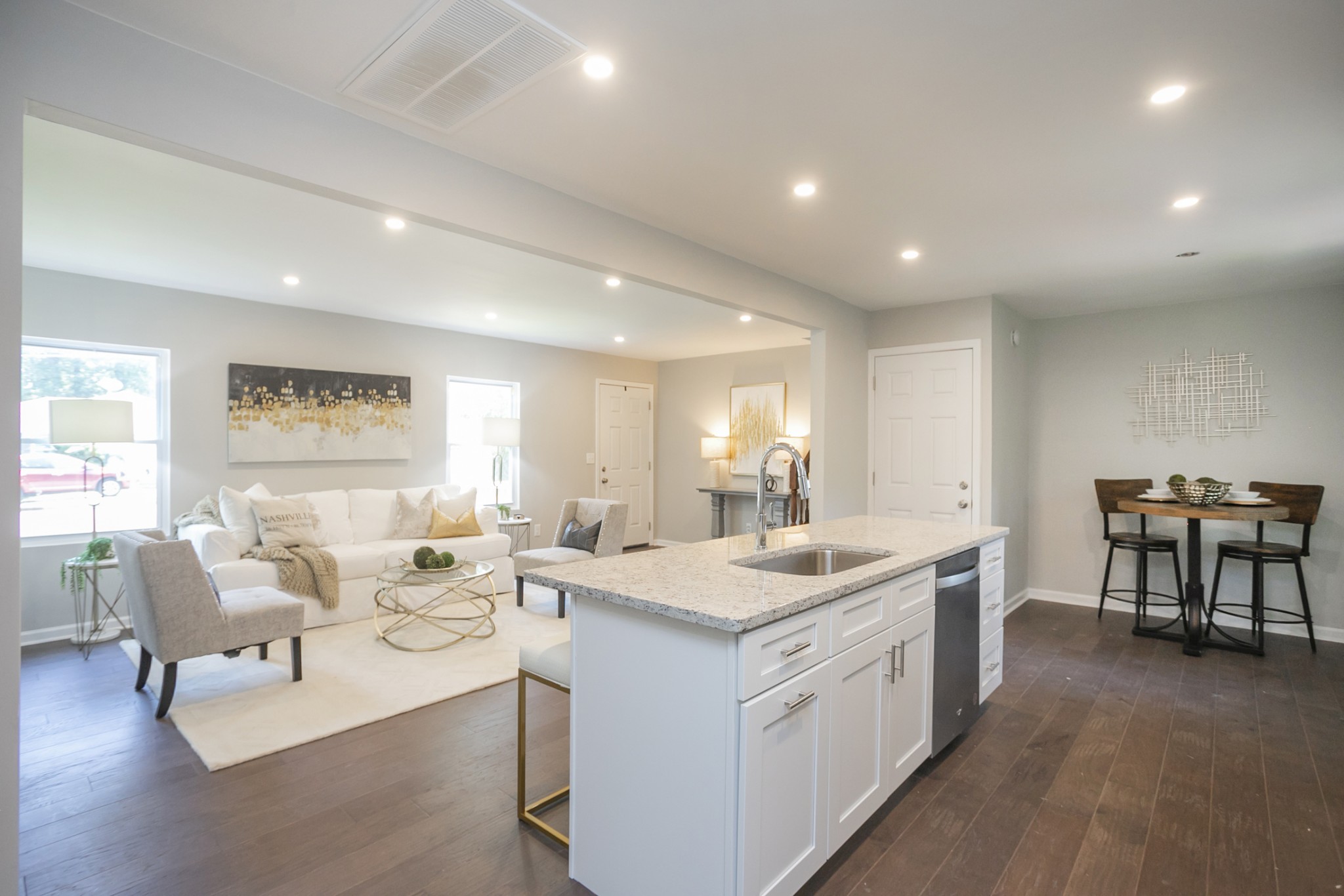 a living room with stainless steel appliances kitchen island granite countertop furniture and a kitchen view