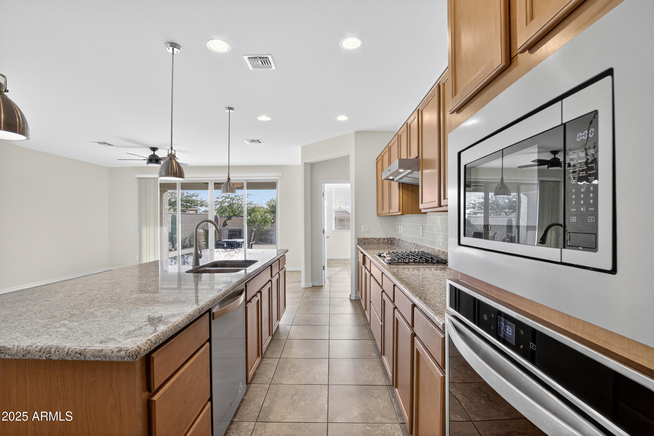 17763 West Granite View Drive Goodyear, AZ 85338 - Photo 11 of 67 a kitchen with stainless steel appliances granite countertop a sink and stove