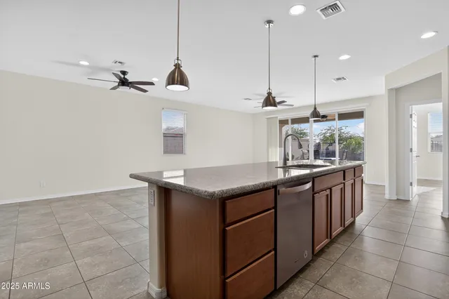 a view of a kitchen with a sink and a refrigerator