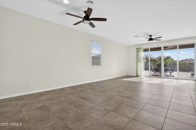 a view of a kitchen with furniture and a ceiling fan