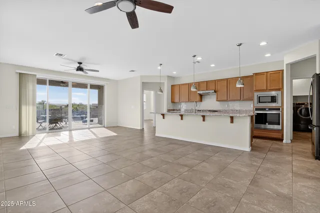 an empty room with closet and a ceiling fan