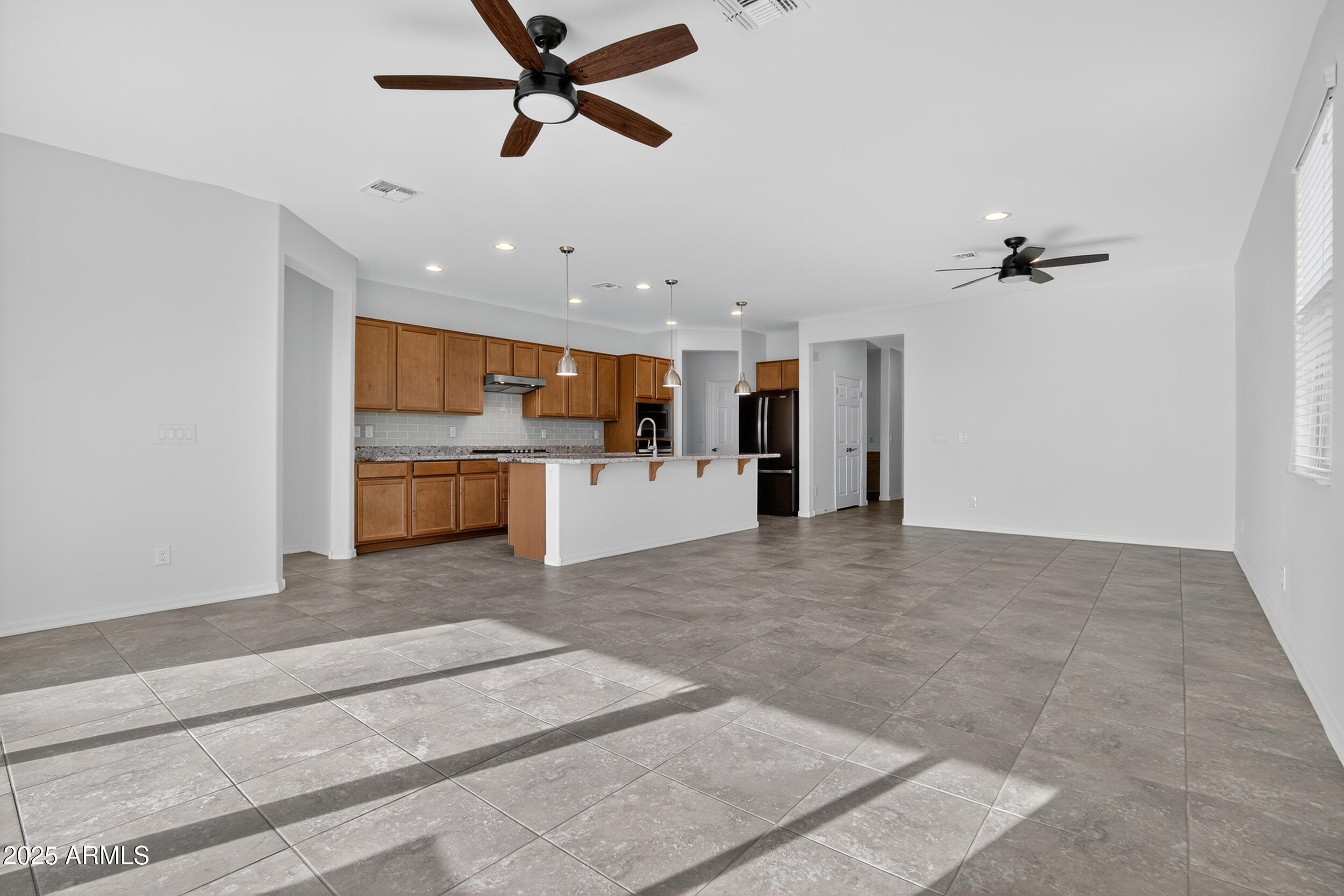 17763 West Granite View Drive Goodyear, AZ 85338 - Photo 16 of 67 a view of a kitchen with a sink and a refrigerator