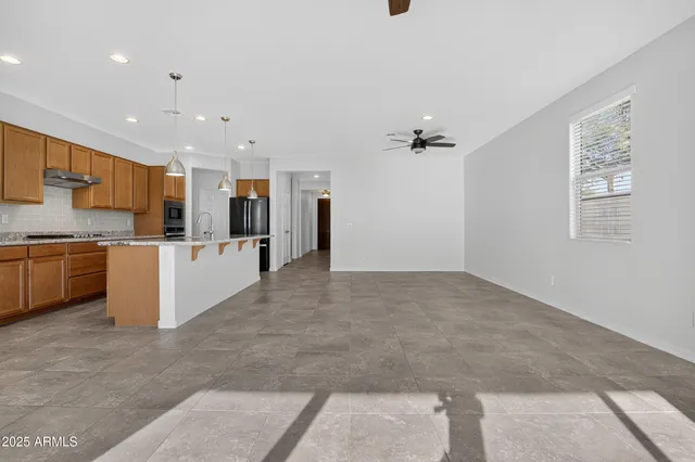 a bathroom with a granite countertop sink a large mirror and a shower