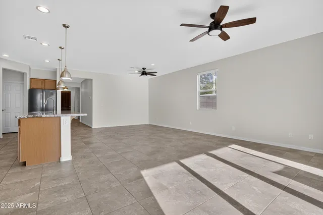 a bathroom with a granite countertop sink a large mirror and a shower