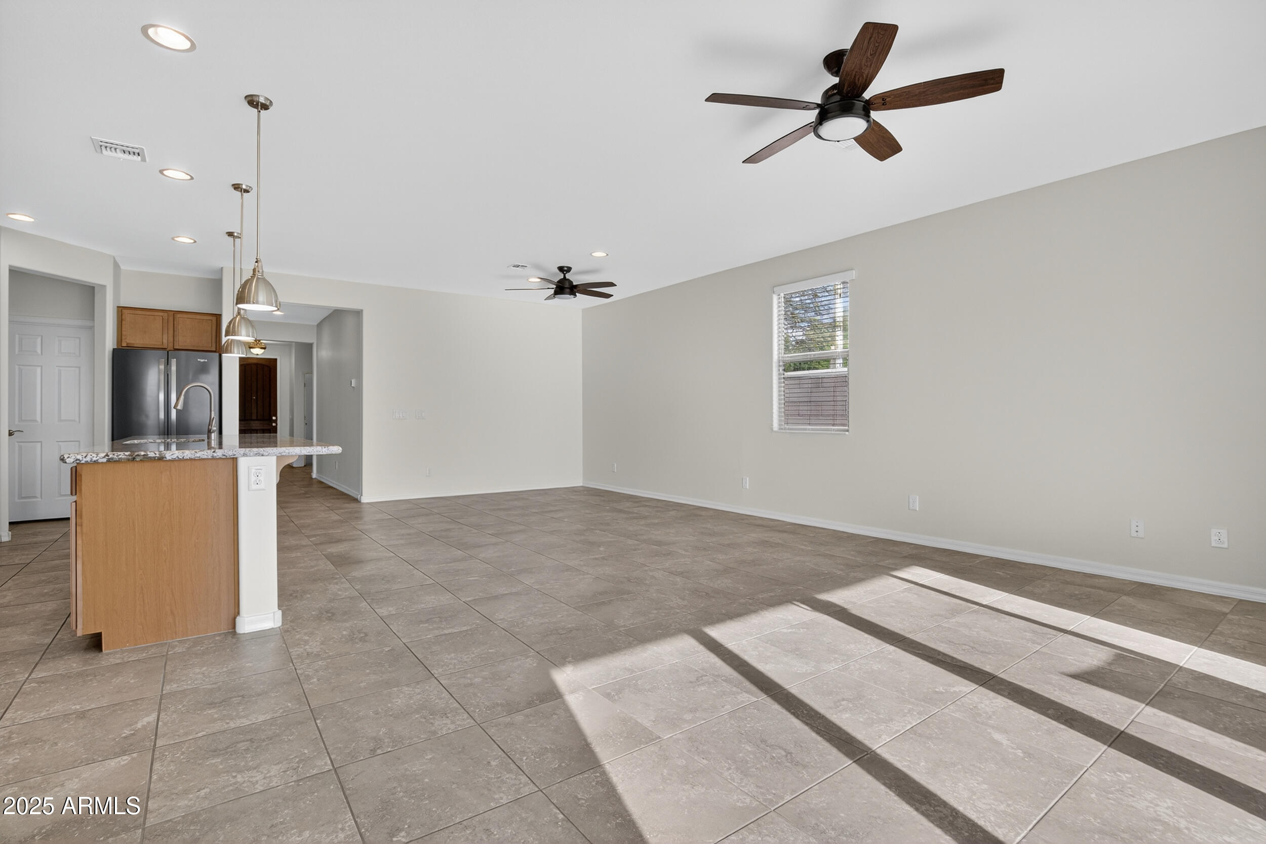17763 West Granite View Drive Goodyear, AZ 85338 - Photo 18 of 67 a view of a kitchen with furniture and a ceiling fan