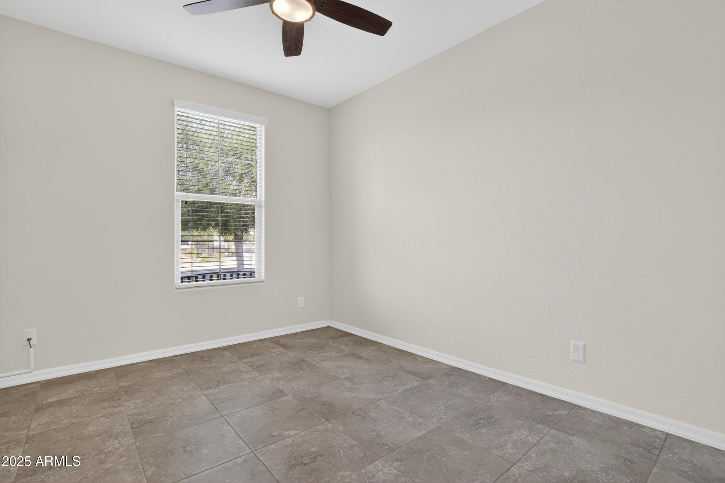 17763 West Granite View Drive Goodyear, AZ 85338 - Photo 30 of 67 an empty room with a window and a fan