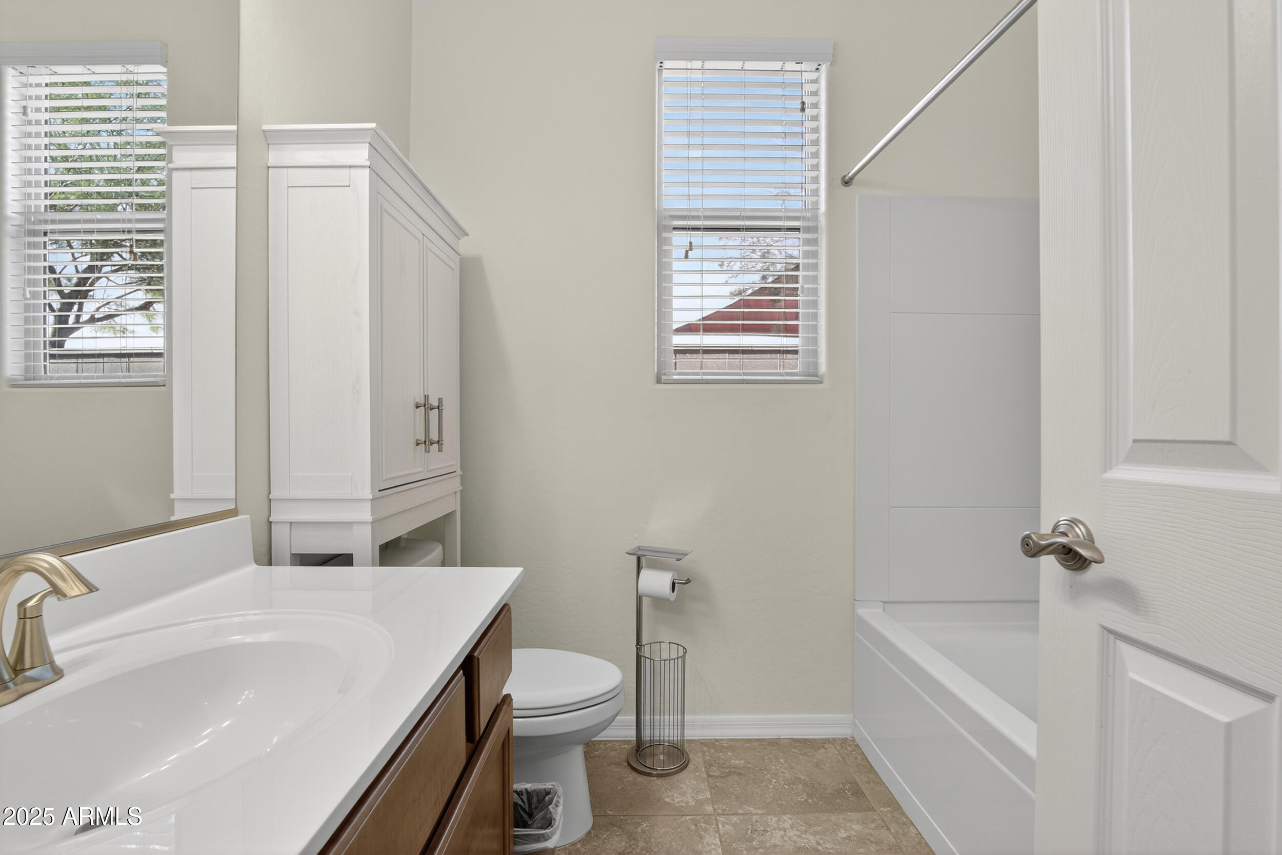 17763 West Granite View Drive Goodyear, AZ 85338 - Photo 33 of 67 a bathroom with a sink a toilet and tub