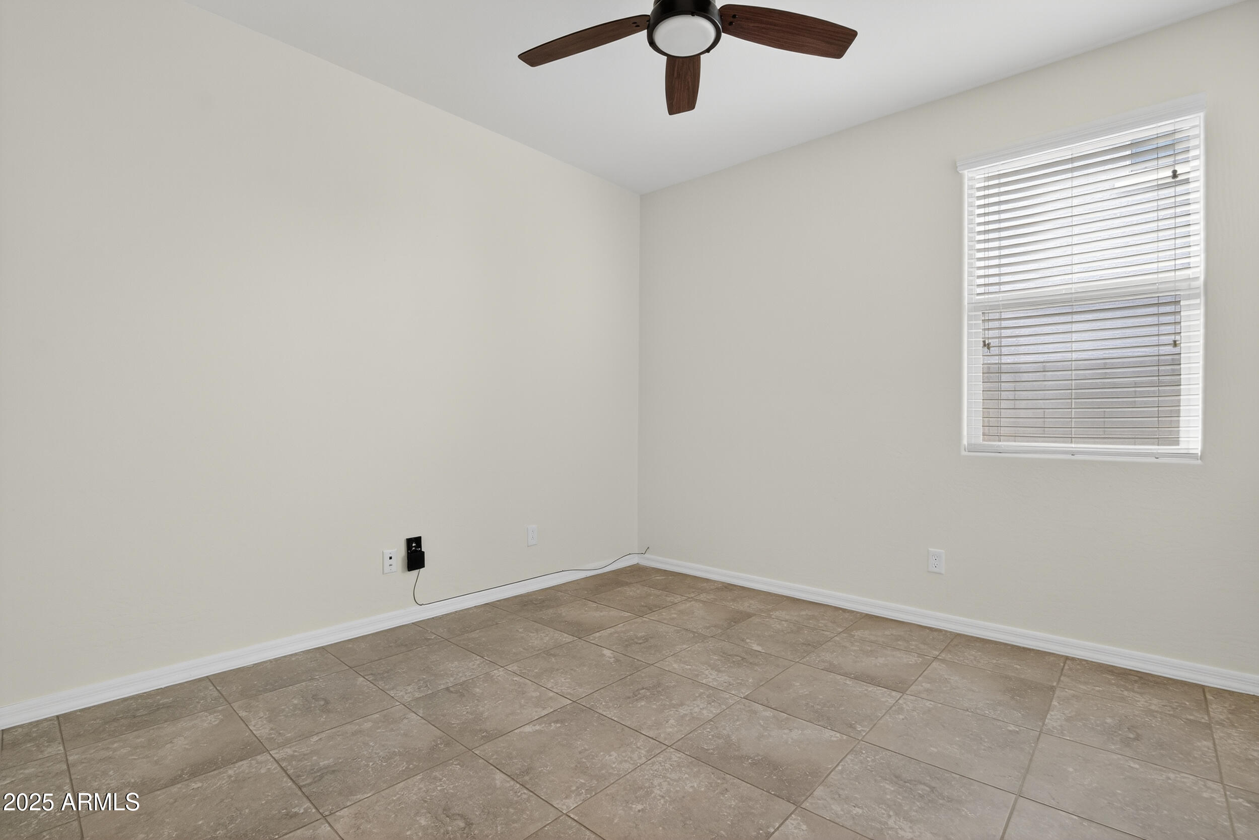 17763 West Granite View Drive Goodyear, AZ 85338 - Photo 34 of 67 an empty room with a window and ceiling fan