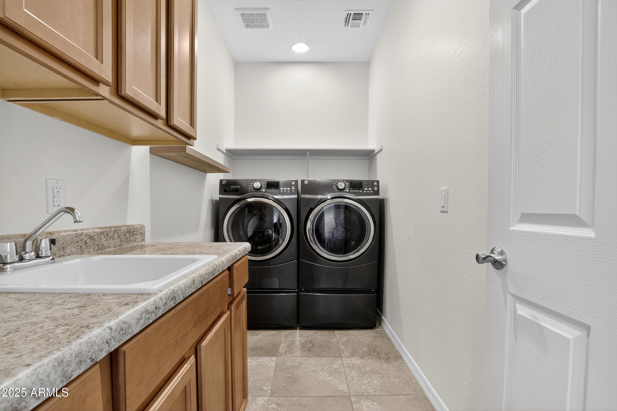 17763 West Granite View Drive Goodyear, AZ 85338 - Photo 37 of 67 a utility room with sink dryer and washer