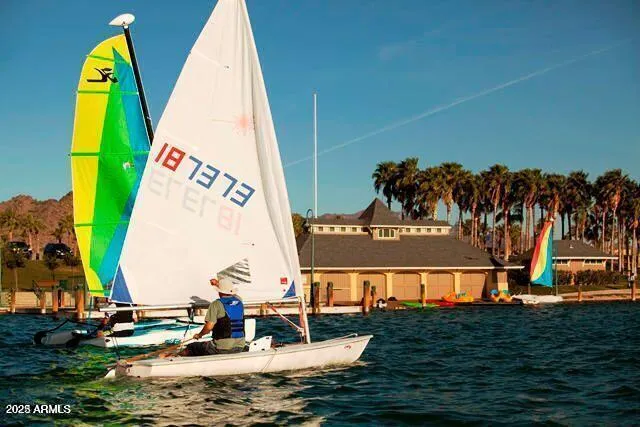 a view of outdoor space with swimming pool and lake view
