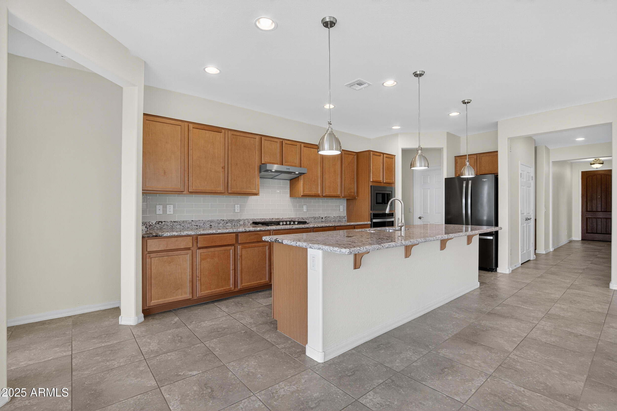 17763 West Granite View Drive Goodyear, AZ 85338 - Photo 8 of 67 a large kitchen with a large counter top appliances and cabinets