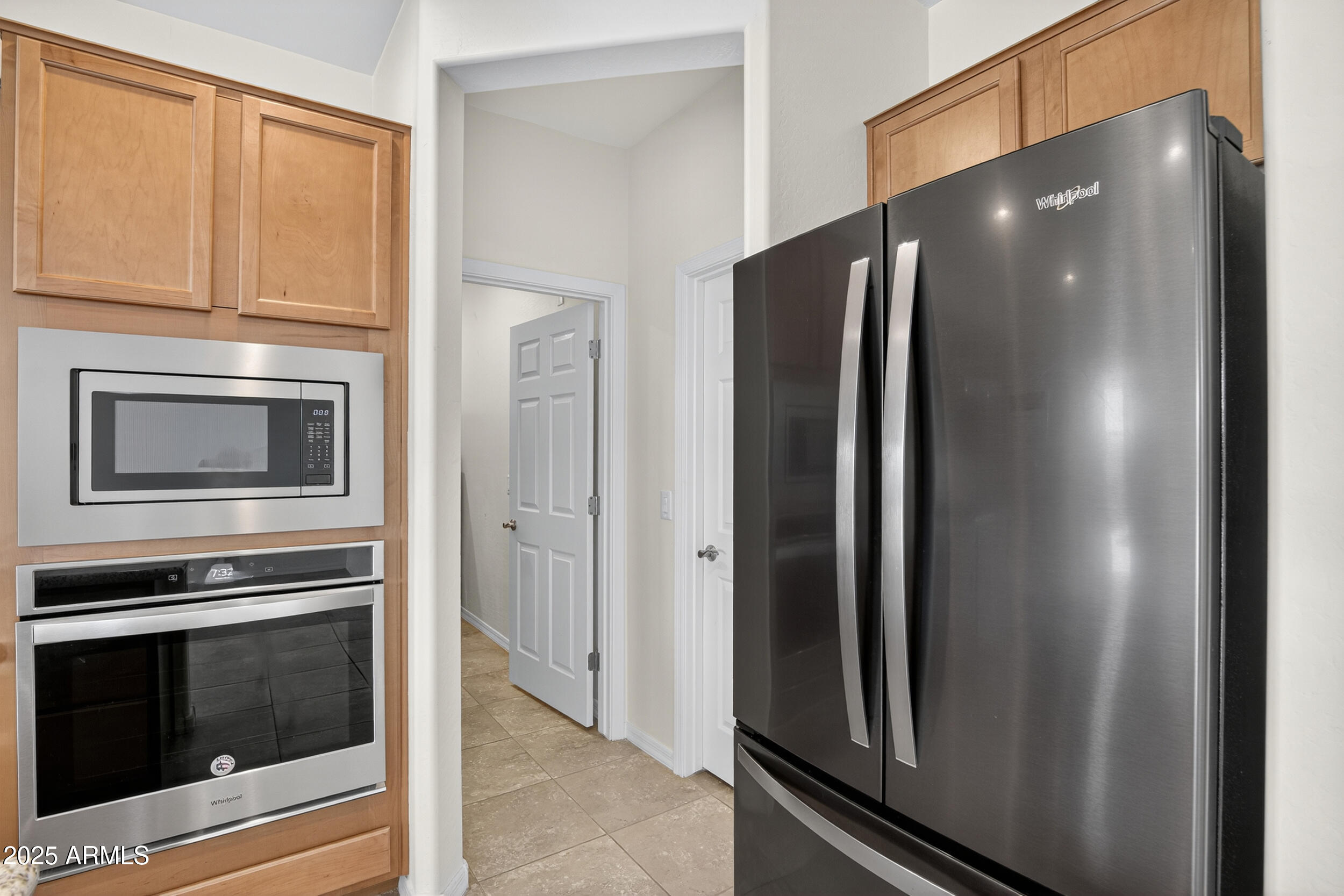 17763 West Granite View Drive Goodyear, AZ 85338 - Photo 10 of 67 a metallic refrigerator freezer and a stove sitting inside of a kitchen