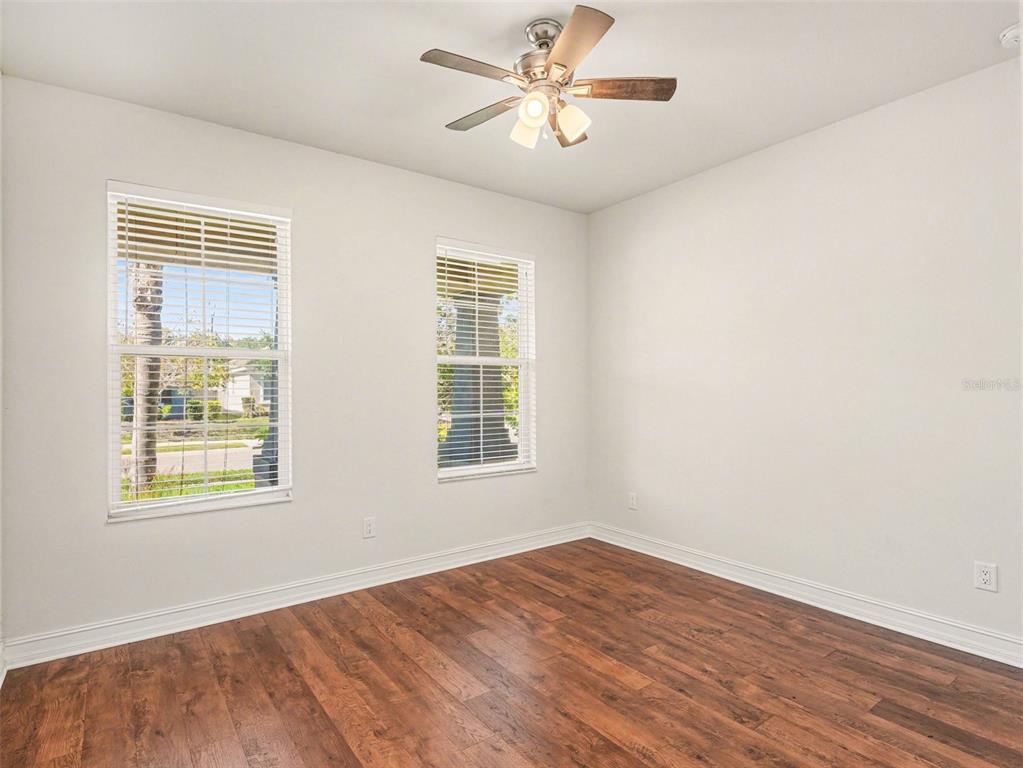 4429 Conchfish Lane Osprey, FL 34229 - Photo 13 of 20 a view of an empty room with wooden floor and a window