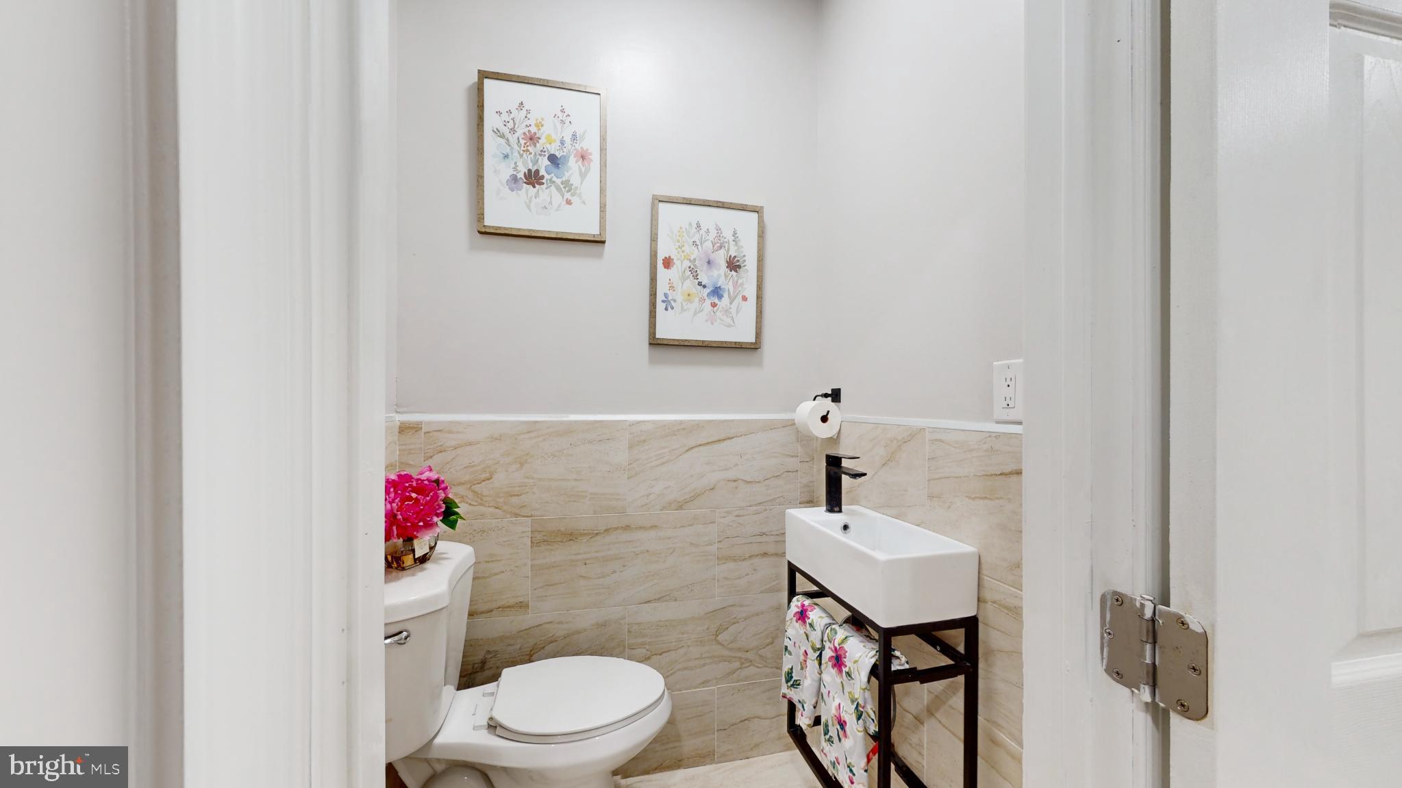 6038 Sansom Street Philadelphia, PA 19139 - Photo 17 of 22 Charming half-bath with floral accents.