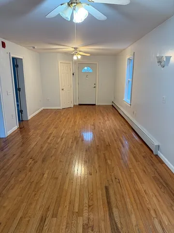wooden floor in an empty room with a window