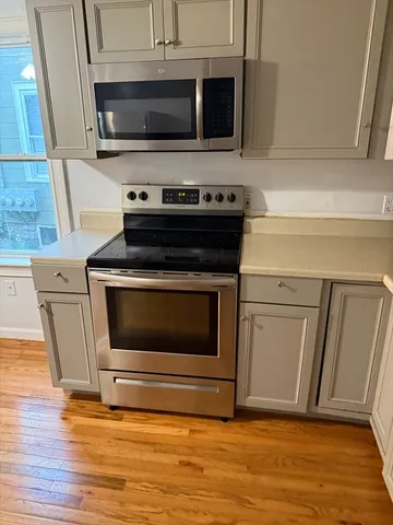 a stove top oven sitting inside of a kitchen