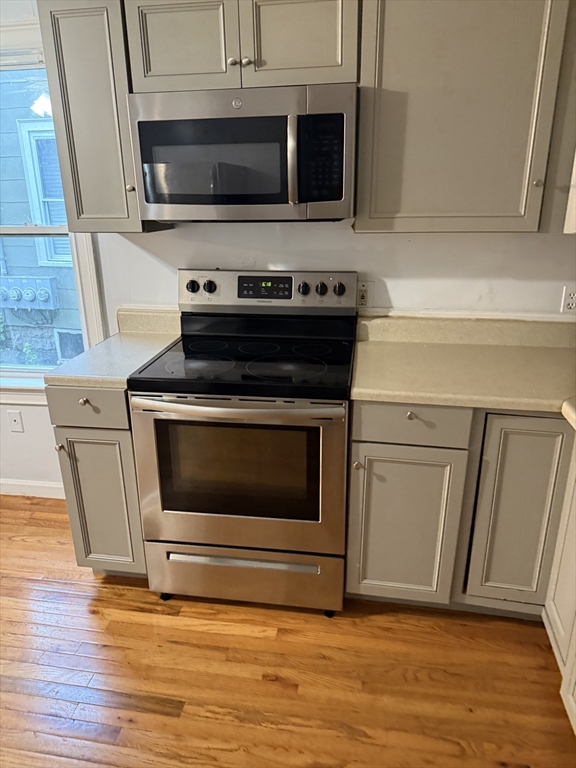 71 Tremont Street, Unit 1 Taunton, MA 02780 - Photo 4 of 9 a stove top oven sitting inside of a kitchen
