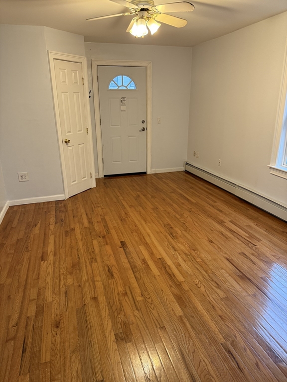 71 Tremont Street, Unit 1 Taunton, MA 02780 - Photo 5 of 9 an empty room with wooden floor and windows