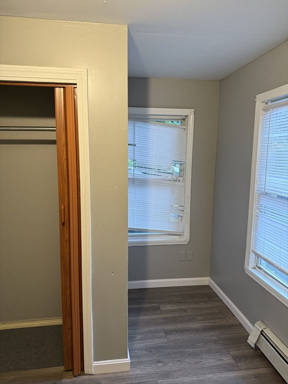 71 Tremont Street, Unit 1 Taunton, MA 02780 - Photo 7 of 9 a view of an empty room with wooden floor and a window