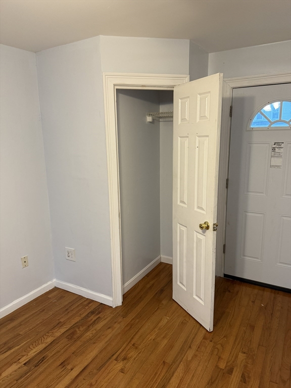 71 Tremont Street, Unit 1 Taunton, MA 02780 - Photo 8 of 9 a view of a room with wooden floor and closet area