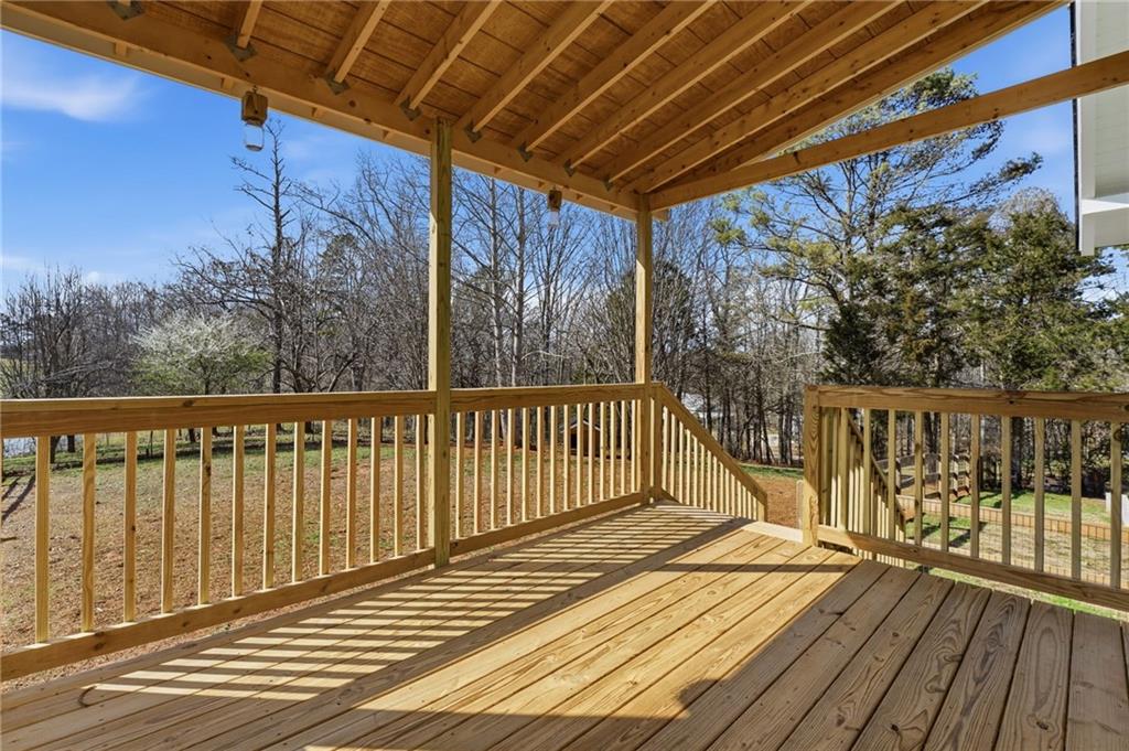 858 Honeysuckle Lane Temple, GA 30179 - Photo 26 of 60 a view of a balcony with wooden floor