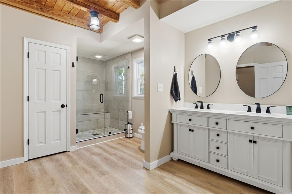 858 Honeysuckle Lane Temple, GA 30179 - Photo 28 of 60 a spacious bathroom with a double vanity sink mirror and a shower