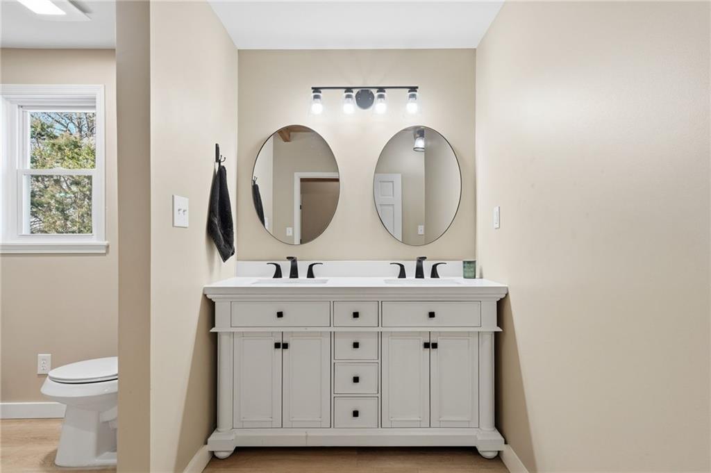 858 Honeysuckle Lane Temple, GA 30179 - Photo 29 of 60 a bathroom with 2 sink and a toilet