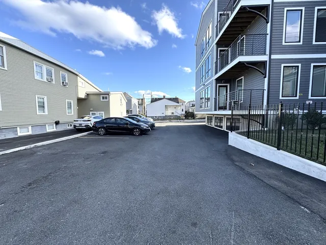 a couple of cars parked in front of a building