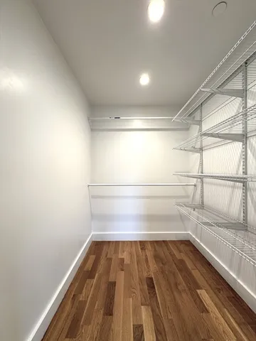 a view of a room with wooden floor and window