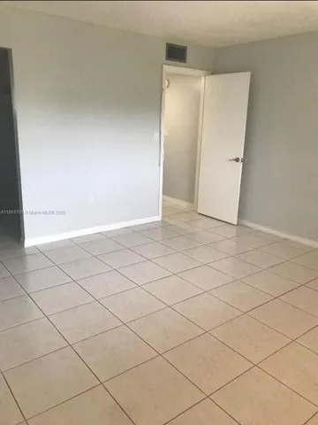 a view of an empty room and utility room