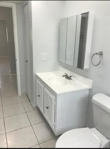 a bathroom with a sink a toilet and mirror