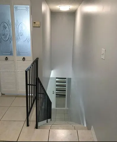 a view of staircase with mirror