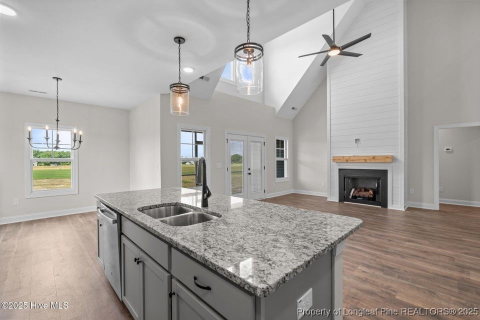 334 Mcbride Road Jackson Springs, NC 27281 - Photo 20 of 47 a kitchen with kitchen island granite countertop a stove a sink and a wooden floor
