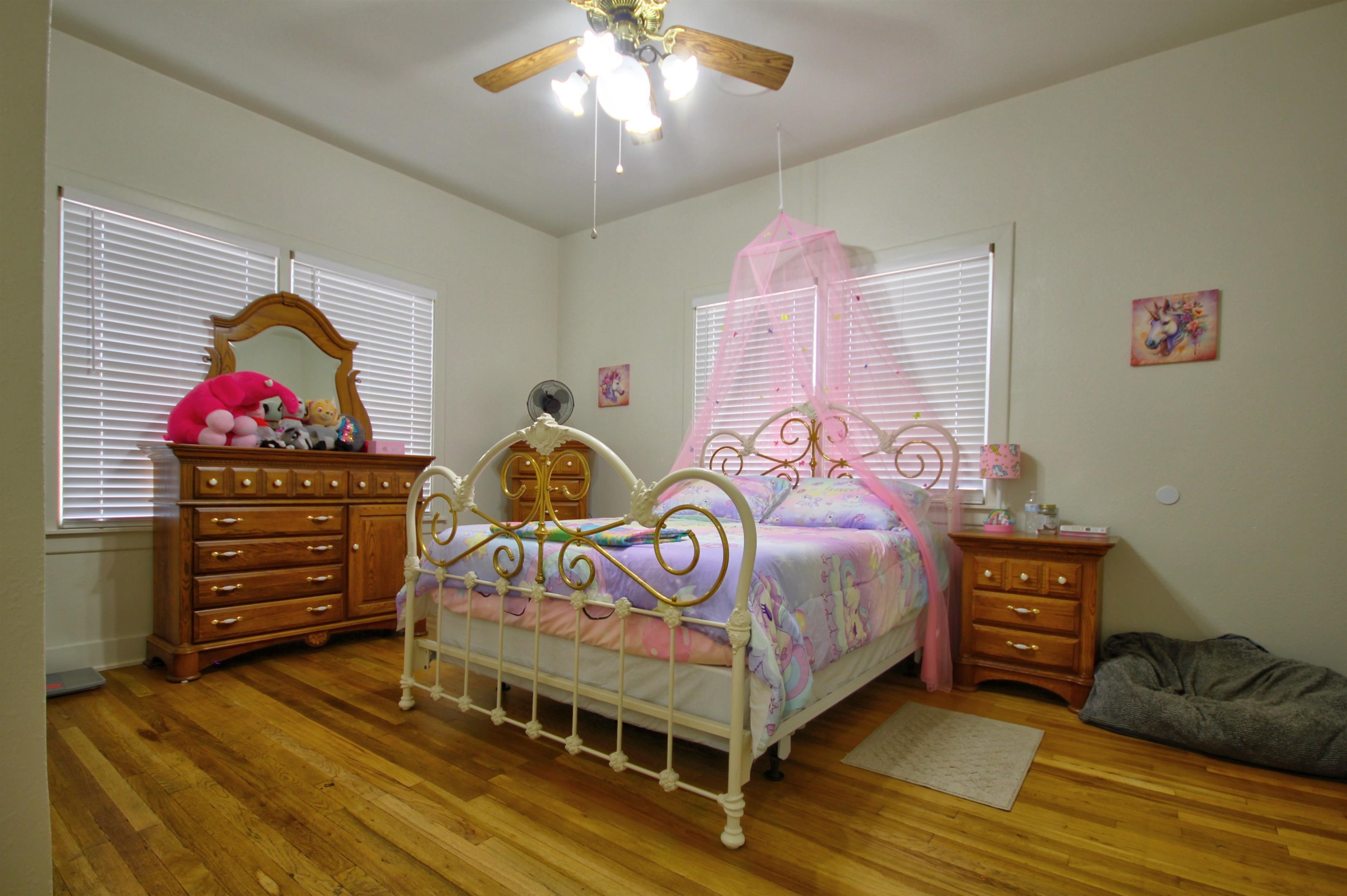1504 Rr 261 - Main Home Buchanan Dam Buchanan Dam, TX 78609 - Photo 14 of 30 a bedroom with a bed and a chandelier