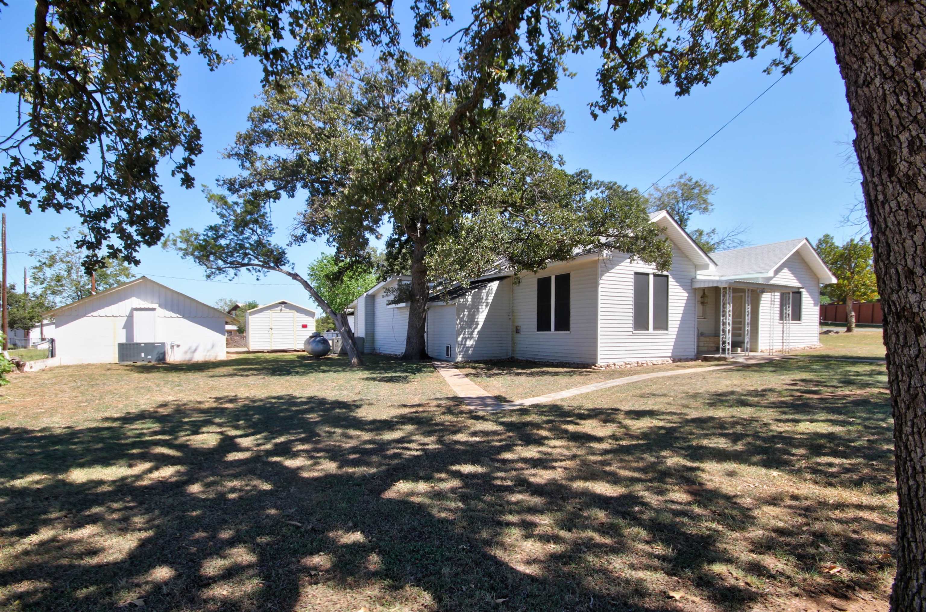 1504 Rr 261 - Main Home Buchanan Dam Buchanan Dam, TX 78609 - Photo 2 of 30 a front view of a house with a yard