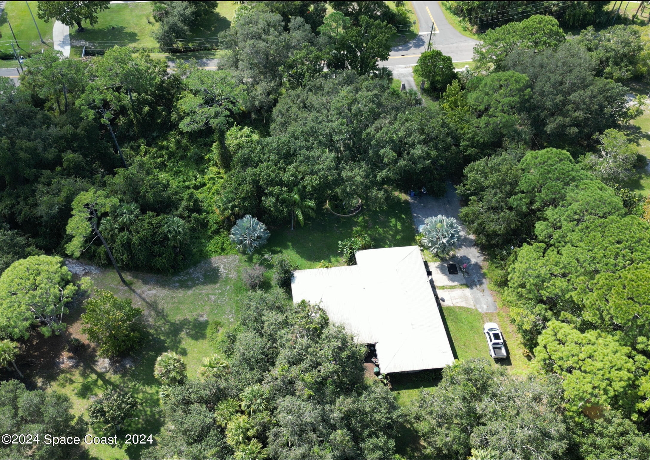 2293 Cox Road Cocoa, FL 32926 - Photo 17 of 18 an aerial view of residential house with outdoor space and trees all around