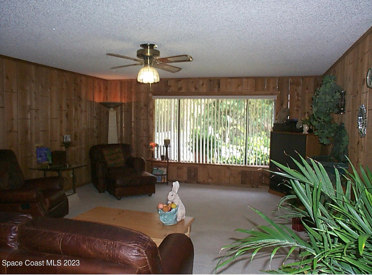 2293 Cox Road Cocoa, FL 32926 - Photo 8 of 18 a living room with furniture and a large window