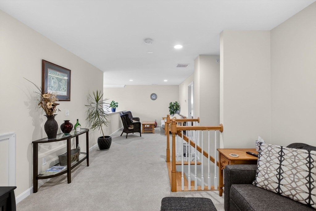 87 Shannon Way, Unit 86 Upton, MA 01568 - Photo 22 of 36 a living room with furniture and stairs